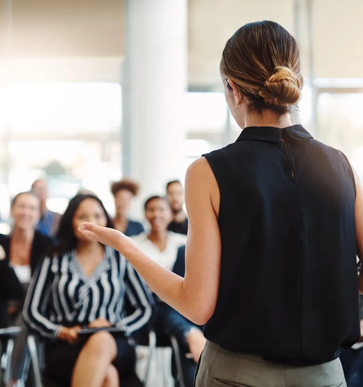 Person giving presentation to attentive audience.