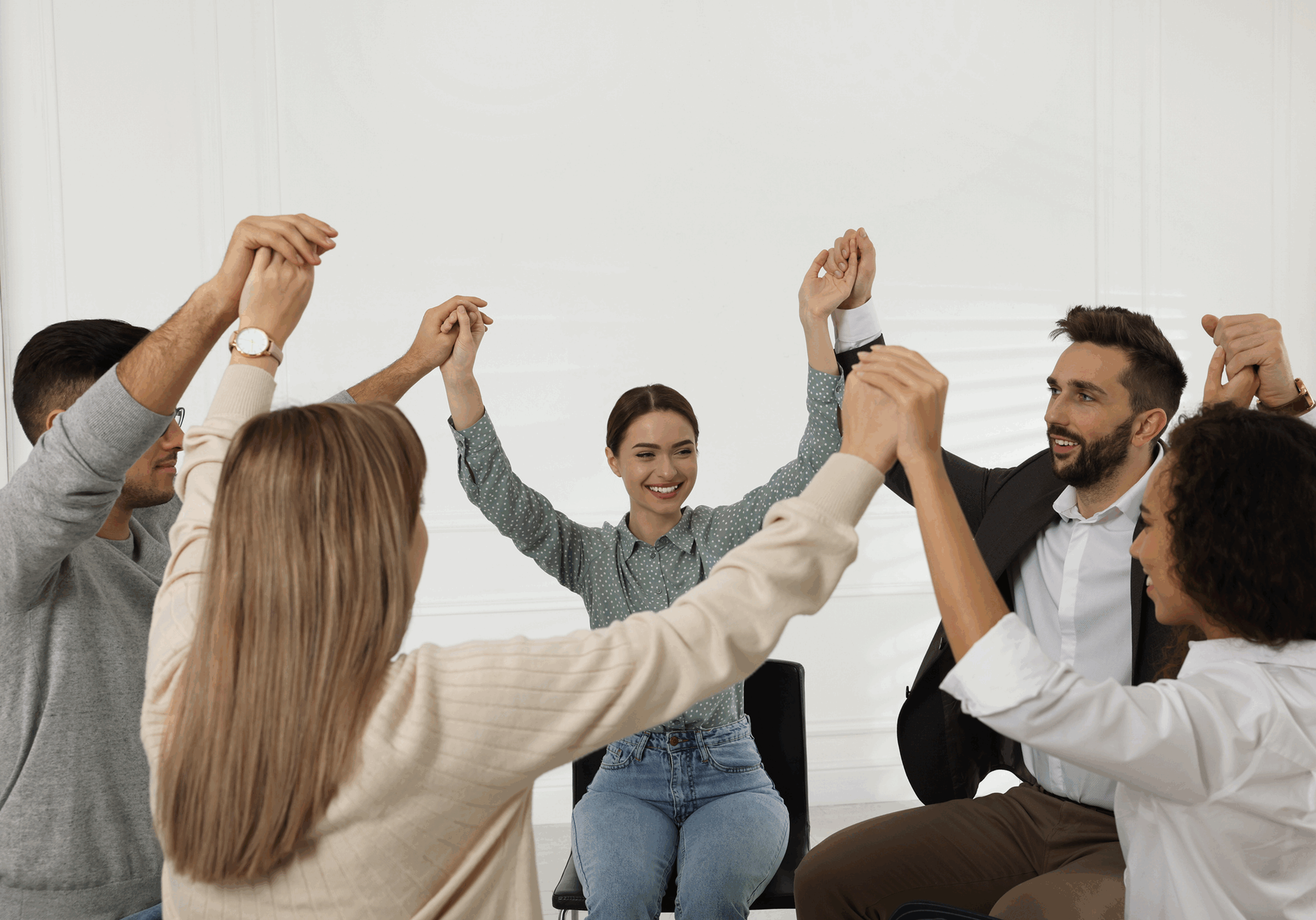 Group bonding activity with raised hands.